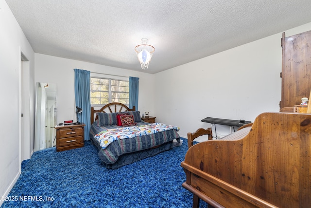 carpeted bedroom featuring a textured ceiling