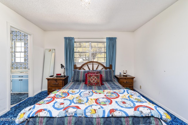 carpeted bedroom featuring connected bathroom, baseboards, and a textured ceiling