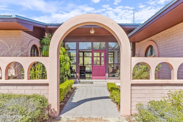 entrance to property featuring french doors and fence