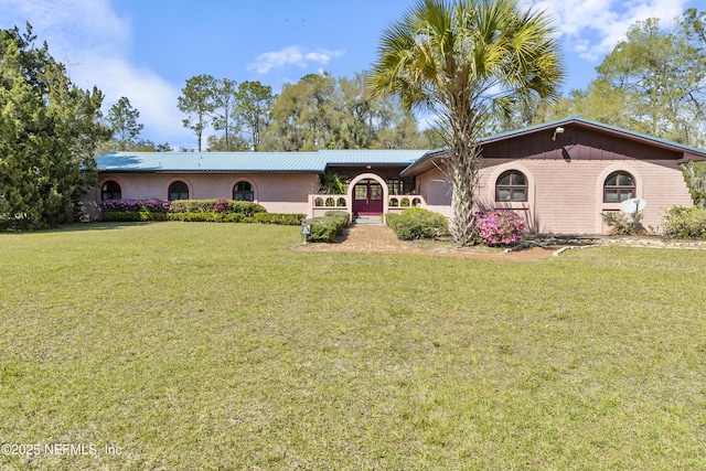 single story home featuring a front lawn
