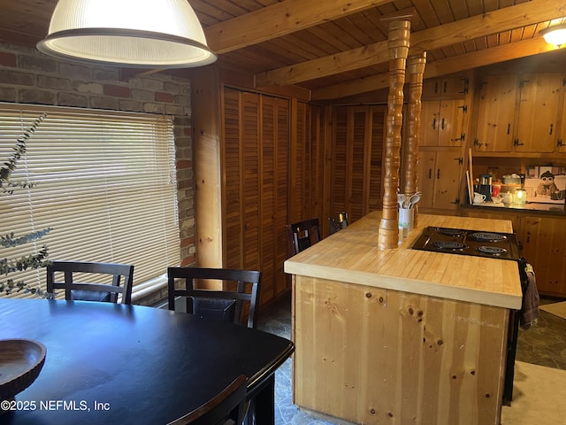 kitchen featuring wood ceiling, wood counters, and beam ceiling