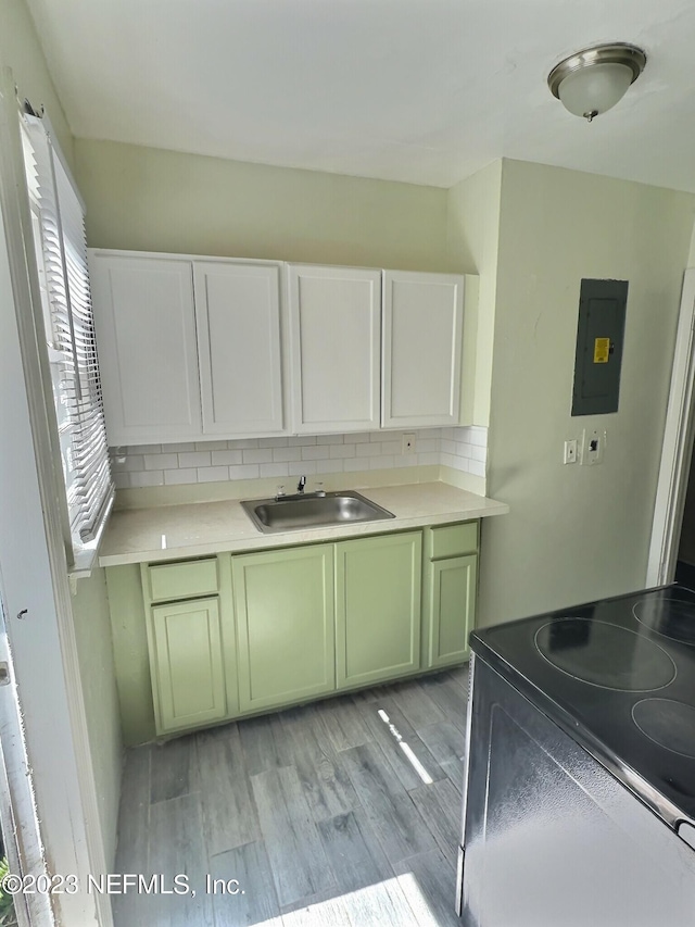 5146 Sunderland Rd, Jacksonville, FL 32210 - kitchen featuring a sink, electric panel, decorative backsplash, electric range, and green cabinetry