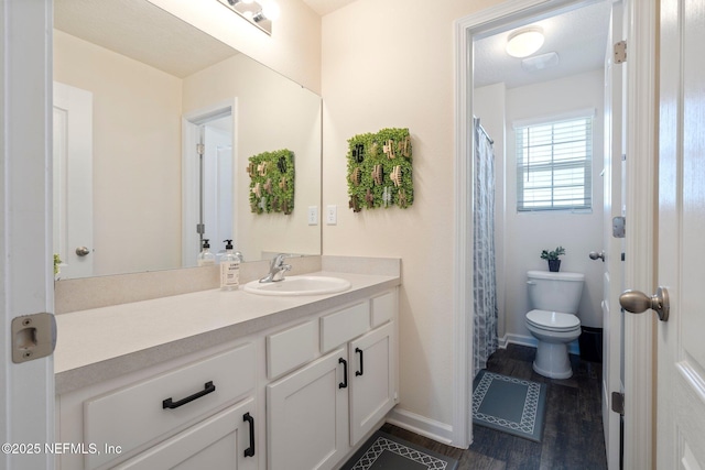 3214 Little Fawn Ln, Green Cove Springs, FL 32043 - bathroom featuring toilet, vanity, baseboards, and wood finished floors