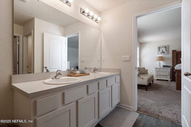 3214 Little Fawn Ln, Green Cove Springs, FL 32043 - ensuite bathroom featuring double vanity, a textured ceiling, ensuite bathroom, and a sink