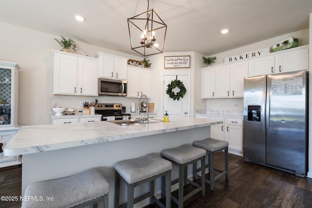 3214 Little Fawn Ln, Green Cove Springs, FL 32043 - kitchen with a sink, stainless steel appliances, dark wood-type flooring, white cabinetry, and a notable chandelier