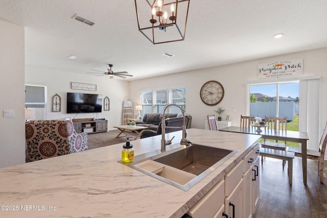 3214 Little Fawn Ln, Green Cove Springs, FL 32043 - kitchen with ceiling fan, white cabinets, visible vents, and a sink