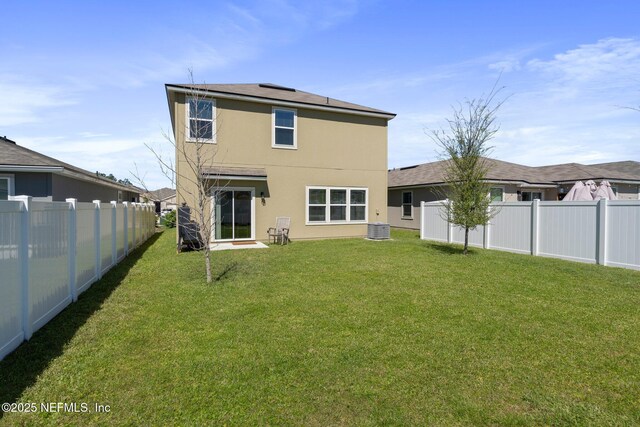 3214 Little Fawn Ln, Green Cove Springs, FL 32043 - back of property with central AC, a lawn, a fenced backyard, and stucco siding