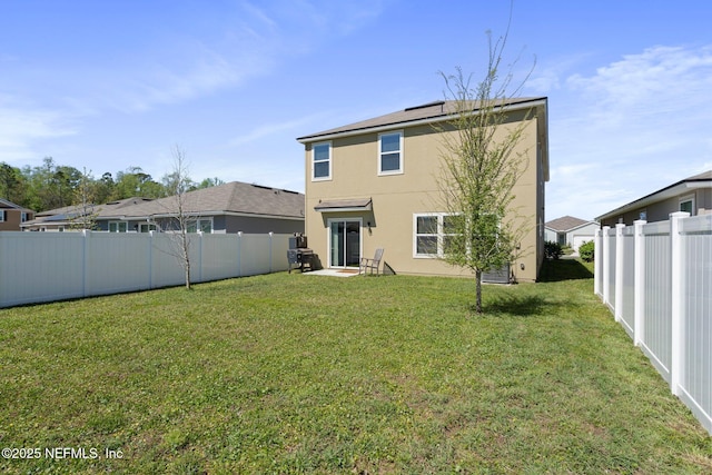 3214 Little Fawn Ln, Green Cove Springs, FL 32043 - back of house featuring a lawn, a fenced backyard, and stucco siding
