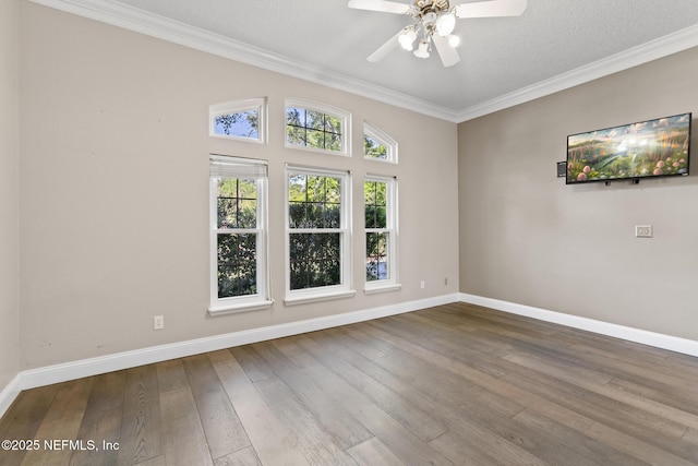 unfurnished room with baseboards, wood-type flooring, crown molding, and a ceiling fan