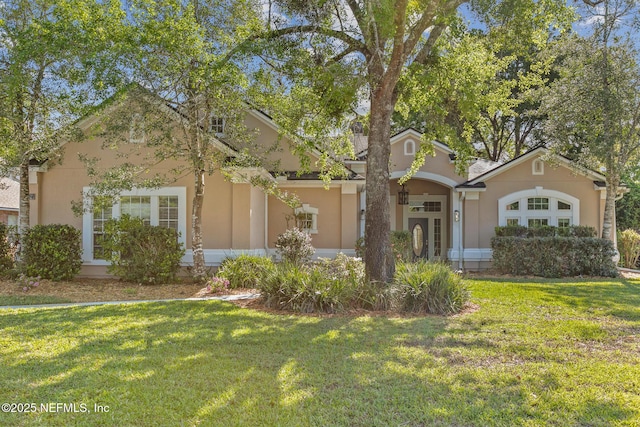 view of front of property with stucco siding and a front yard