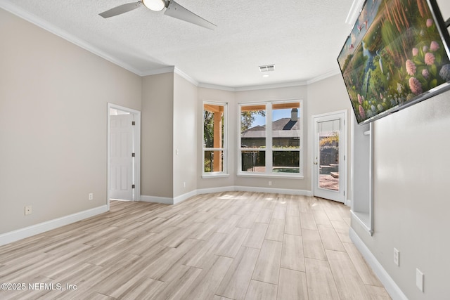 empty room featuring baseboards, light wood-style flooring, ceiling fan, and visible vents