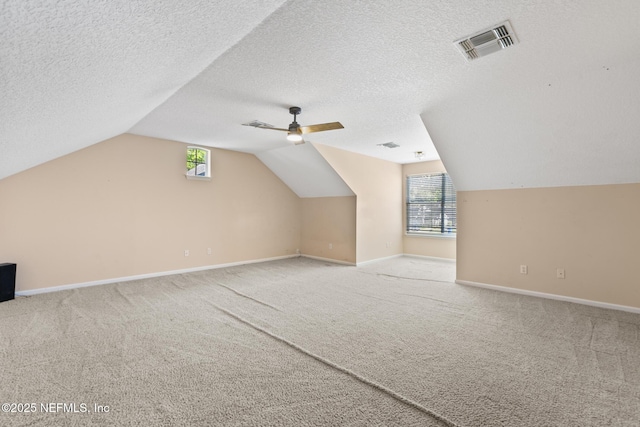 bonus room with baseboards, ceiling fan, visible vents, and carpet