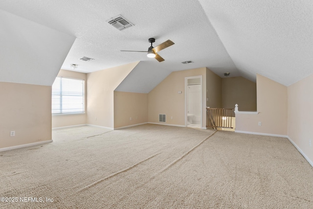additional living space with vaulted ceiling and visible vents