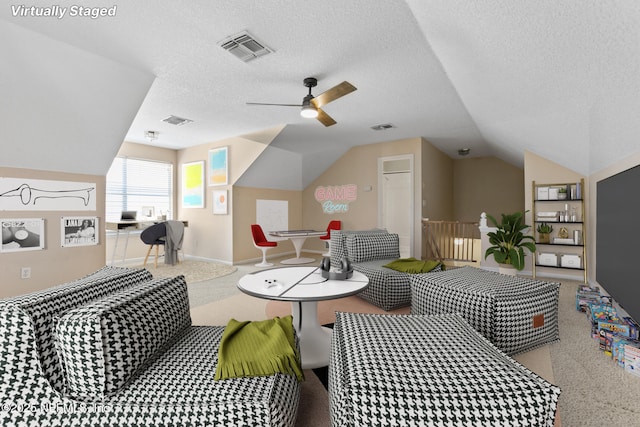 interior space with visible vents, a ceiling fan, and vaulted ceiling