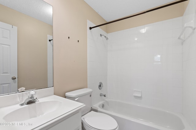 bathroom with a textured ceiling, toilet, vanity, and shower / washtub combination