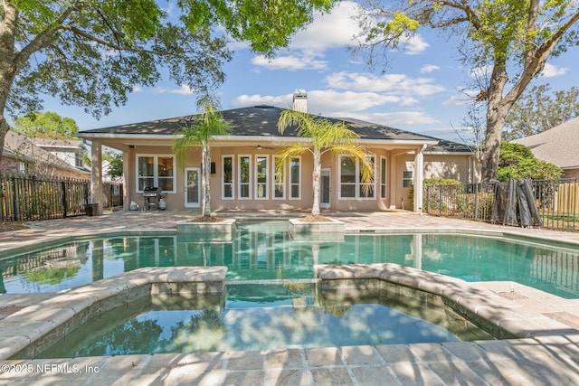 view of swimming pool featuring a fenced backyard, grilling area, a pool with connected hot tub, and a patio