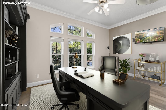office area with baseboards, crown molding, wood finished floors, and ceiling fan