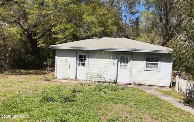 view of outbuilding featuring fence