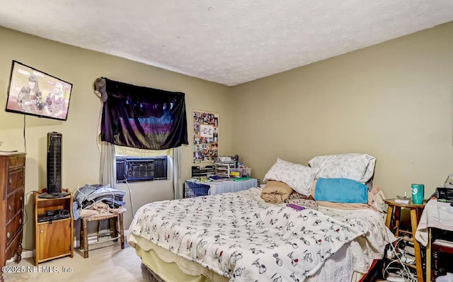 bedroom featuring cooling unit, a textured ceiling, and carpet floors