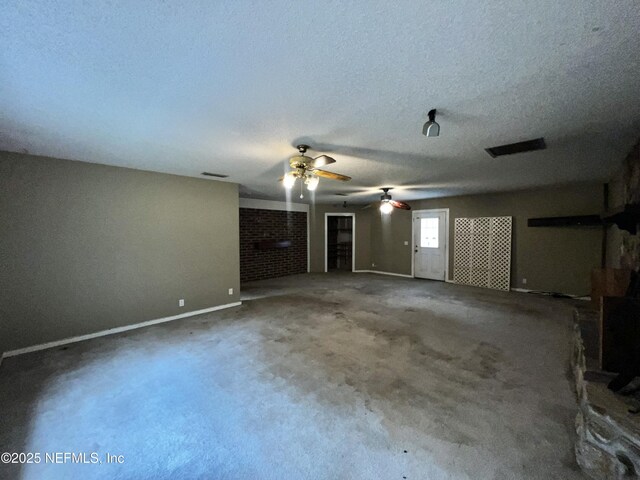2731 Howard Rd, Middleburg, FL 32068 - unfurnished living room featuring a ceiling fan, carpet flooring, and a textured ceiling