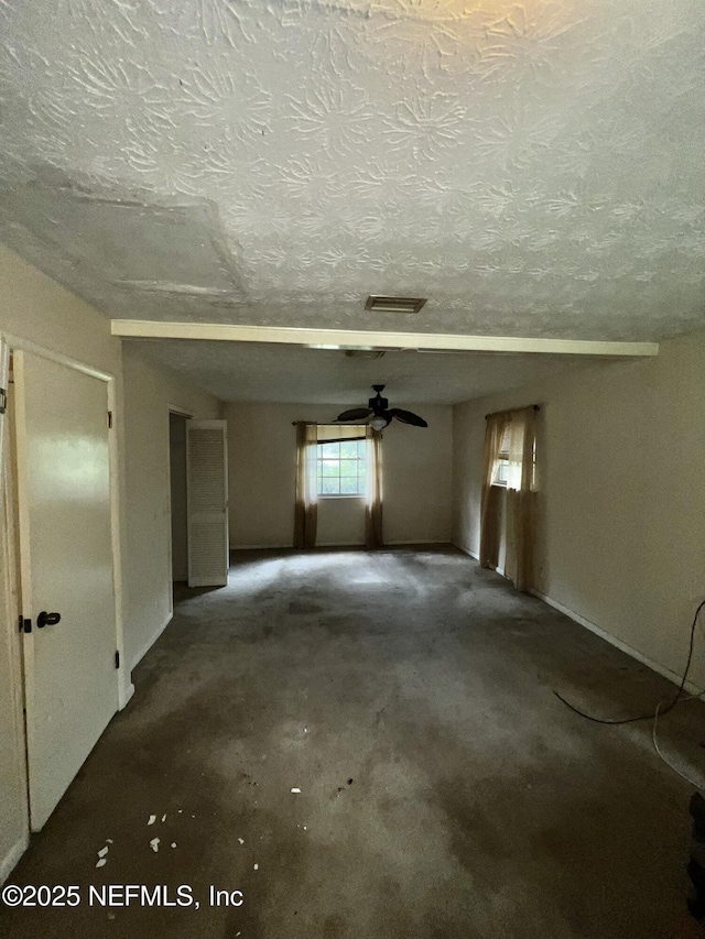 2731 Howard Rd, Middleburg, FL 32068 - unfurnished room with a textured ceiling, unfinished concrete floors, and a ceiling fan