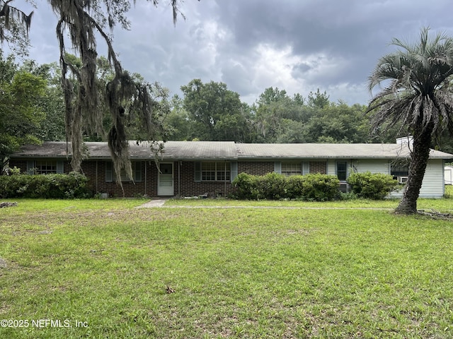 2731 Howard Rd, Middleburg, FL 32068 - ranch-style house with a front lawn and brick siding