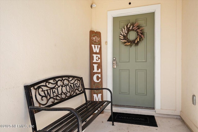 entrance to property with stucco siding