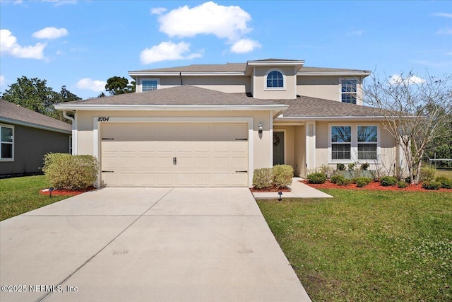 prairie-style house featuring stucco siding, an attached garage, concrete driveway, and a front lawn