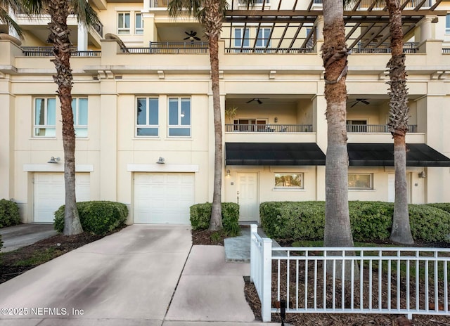 525 3rd St N Unit 210, Jacksonville Beach, FL 32250 - view of building exterior with driveway and a garage