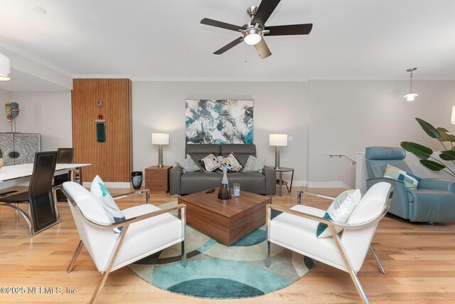 525 3rd St N Unit 210, Jacksonville Beach, FL 32250 - living room featuring baseboards, a ceiling fan, light wood-style flooring, and crown molding