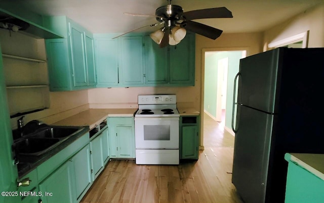 86798 Hester Dr, Yulee, FL 32097 - kitchen featuring white electric range, ceiling fan, freestanding refrigerator, a sink, and green cabinetry