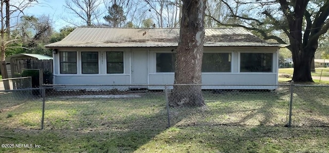 86798 Hester Dr, Yulee, FL 32097 - view of front of property featuring a front lawn, fence, and metal roof