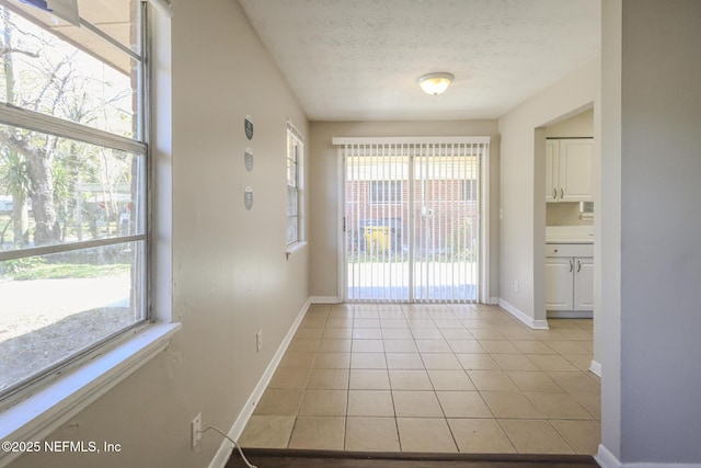 2108 W 15th St, Jacksonville, FL 32209 - interior space with light tile patterned flooring, a textured ceiling, and baseboards