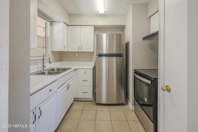 2108 W 15th St, Jacksonville, FL 32209 - kitchen with a sink, range with electric cooktop, white cabinets, and freestanding refrigerator