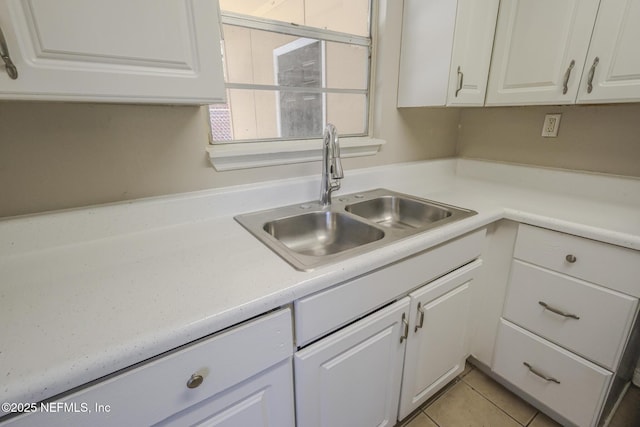 2108 W 15th St, Jacksonville, FL 32209 - kitchen with light countertops, white cabinets, light tile patterned floors, and a sink