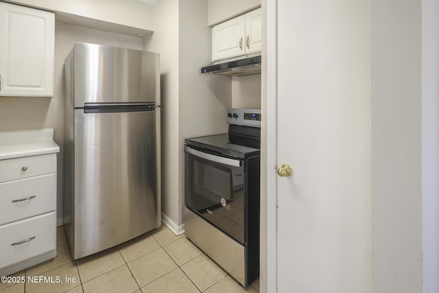 2108 W 15th St, Jacksonville, FL 32209 - kitchen featuring light tile patterned floors, stainless steel appliances, light countertops, white cabinets, and under cabinet range hood