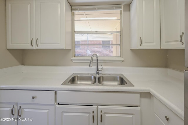 2108 W 15th St, Jacksonville, FL 32209 - kitchen with white cabinetry, light countertops, and a sink