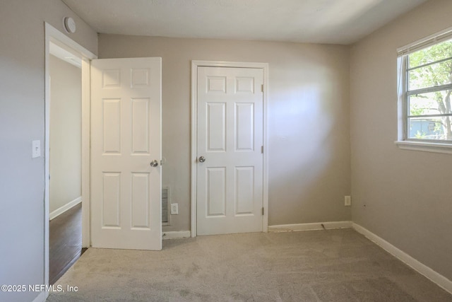 2108 W 15th St, Jacksonville, FL 32209 - unfurnished bedroom with baseboards and carpet floors