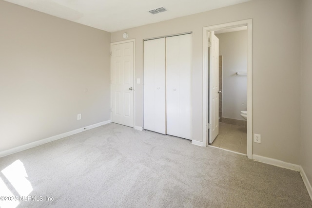 2108 W 15th St, Jacksonville, FL 32209 - unfurnished bedroom with visible vents, baseboards, carpet floors, ensuite bathroom, and a closet