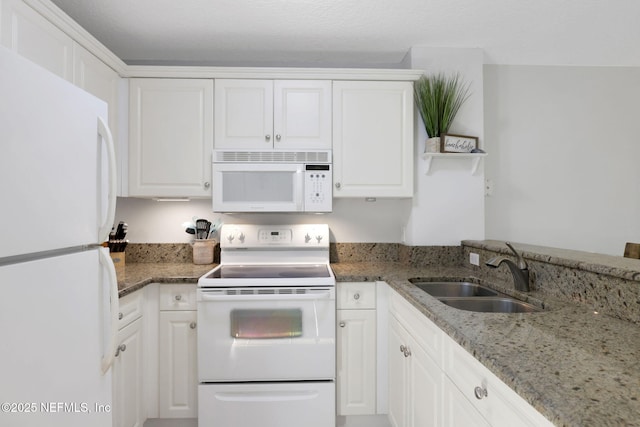 2114 Gail Ave Unit A, Jacksonville Beach, FL 32250 - kitchen featuring light stone counters, white cabinetry, a sink, and white appliances