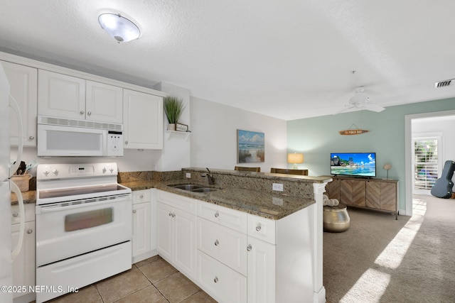 2114 Gail Ave Unit A, Jacksonville Beach, FL 32250 - kitchen with a sink, open floor plan, white appliances, white cabinets, and a peninsula