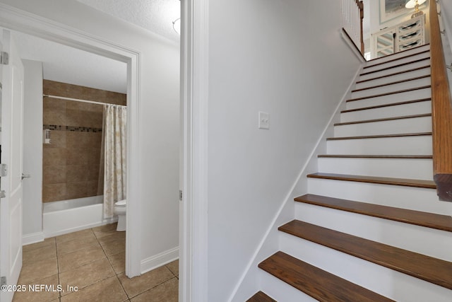 2114 Gail Ave Unit A, Jacksonville Beach, FL 32250 - stairway with tile patterned floors, baseboards, and a textured ceiling
