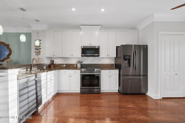 2114 Gail Ave Unit A, Jacksonville Beach, FL 32250 - kitchen with a sink, white cabinetry, decorative backsplash, appliances with stainless steel finishes, and ornamental molding