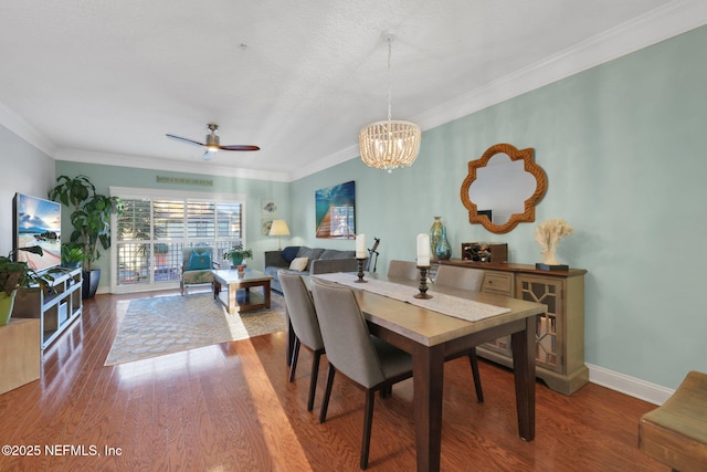 2114 Gail Ave Unit A, Jacksonville Beach, FL 32250 - dining space with wood finished floors, crown molding, baseboards, and ceiling fan with notable chandelier