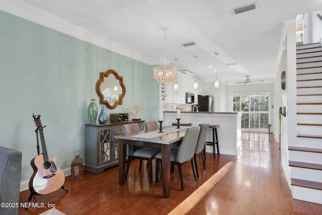 2114 Gail Ave Unit A, Jacksonville Beach, FL 32250 - dining space with baseboards, visible vents, wood finished floors, stairway, and crown molding
