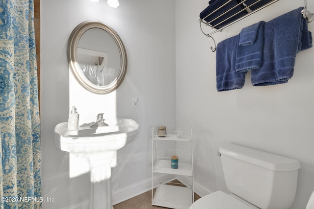 2114 Gail Ave Unit A, Jacksonville Beach, FL 32250 - bathroom featuring a shower with shower curtain, toilet, baseboards, and tile patterned floors