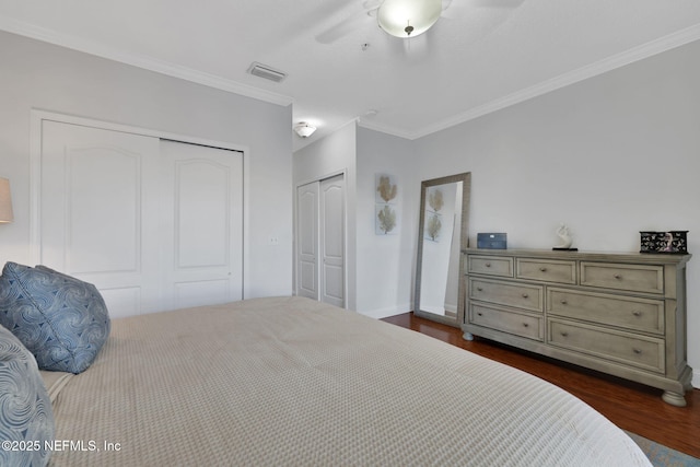 2114 Gail Ave Unit A, Jacksonville Beach, FL 32250 - bedroom featuring dark wood-style flooring, visible vents, a ceiling fan, multiple closets, and ornamental molding