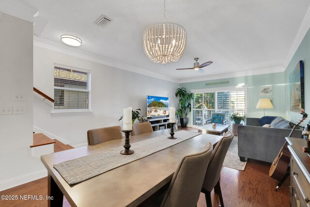2114 Gail Ave Unit A, Jacksonville Beach, FL 32250 - dining area featuring visible vents, crown molding, dark wood-style floors, and ceiling fan with notable chandelier