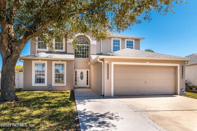 11 Reeding Ridge Dr W, Jacksonville, FL 32225 - view of front facade with stucco siding, a front lawn, a garage, and driveway