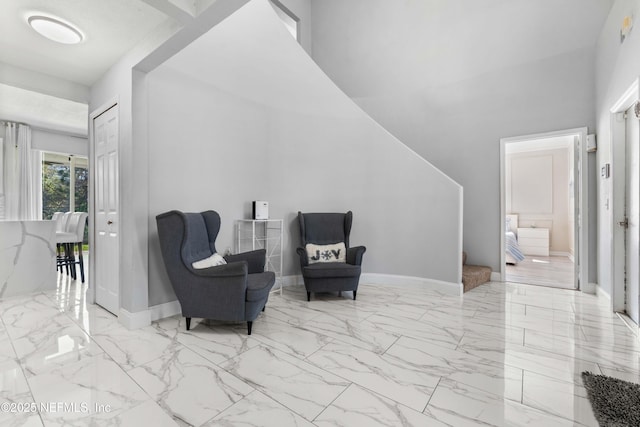 11 Reeding Ridge Dr W, Jacksonville, FL 32225 - living area featuring baseboards, marble finish floor, and a towering ceiling